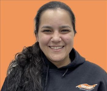 woman in front of orange wall